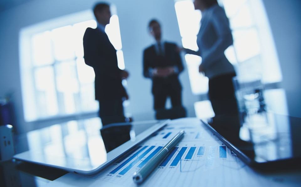 financial-report-with-co-workers-blurred-background (1) team meat